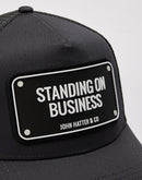 John Hatter and Co Standing On Business Cap