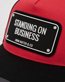 John Hatter and Co Standing On Business Cap